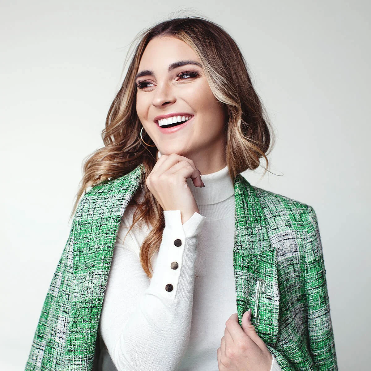 MINT campaign portrait in a green tweed jacket
