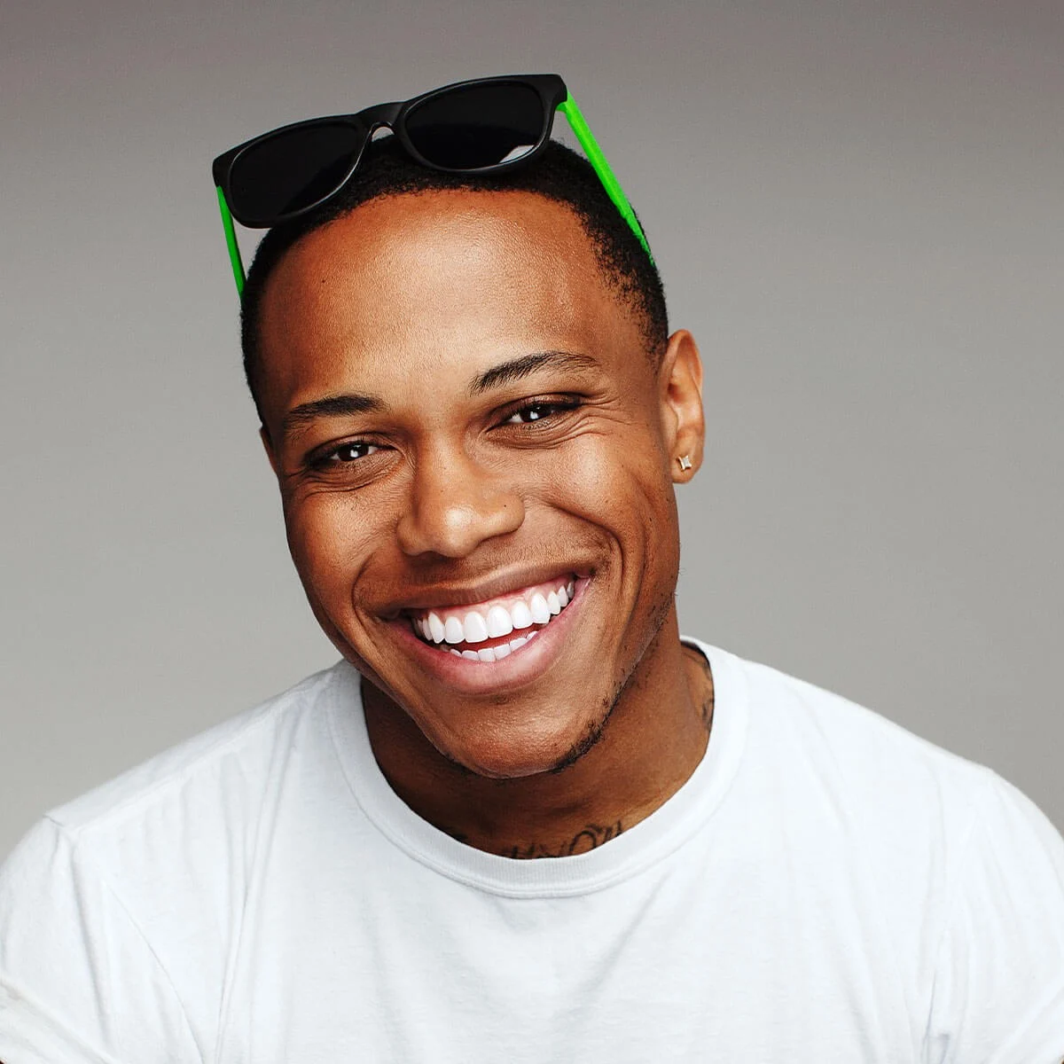 MINT campaign portrait with green-accented sunglasses