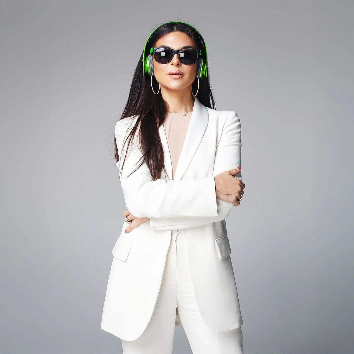 MINT campaign portrait in a white suit with green headphones